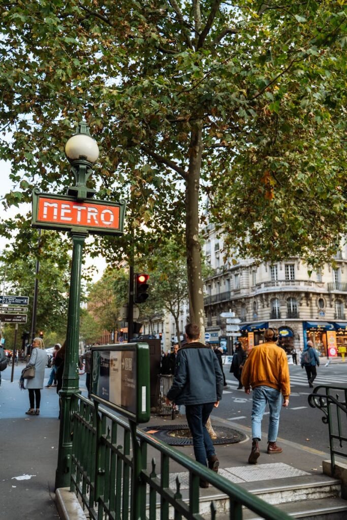 A lively Parisian street scene featuring the iconic Metro sign and bustling pedestrians.