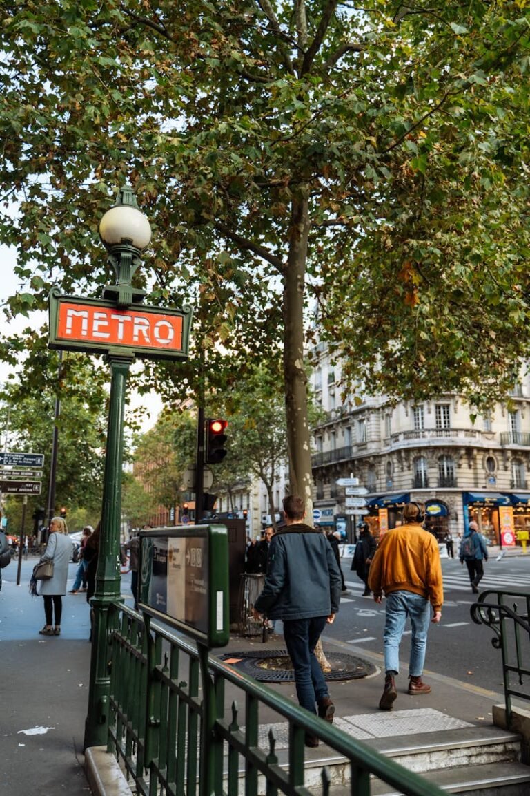A lively Parisian street scene featuring the iconic Metro sign and bustling pedestrians.