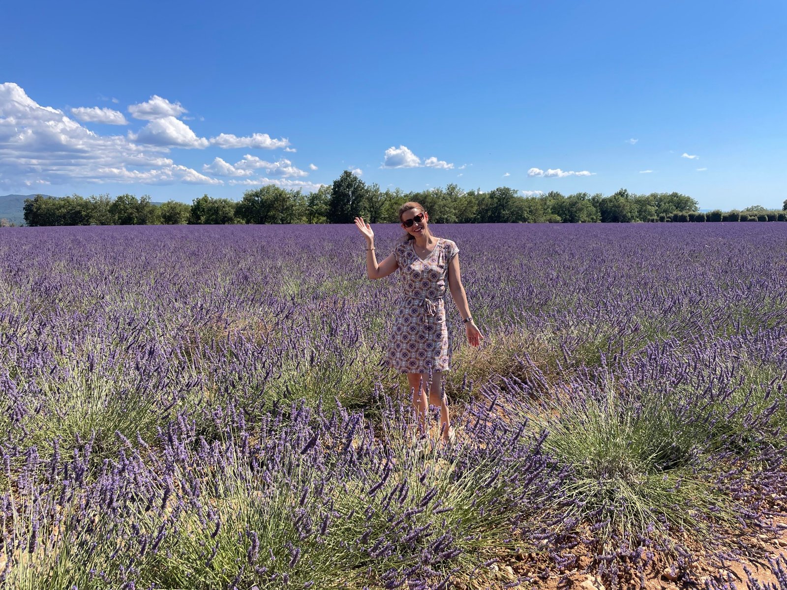 A woman stands in a lavender field in Valensole, Provence France