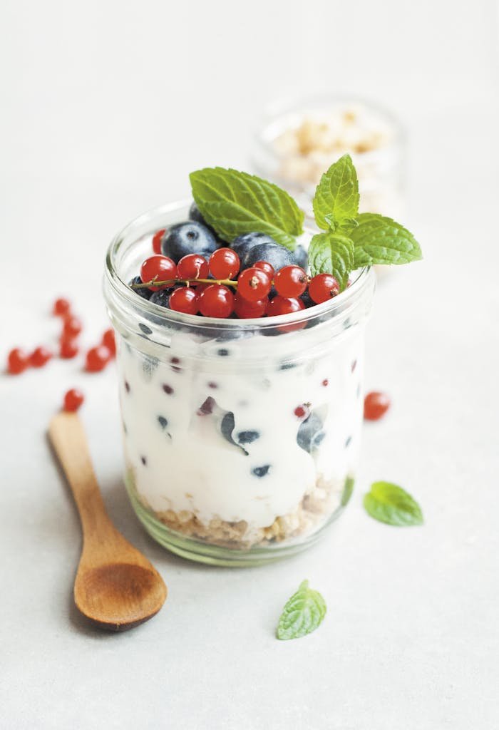 A delicious yogurt parfait with fresh berries and mint leaves.