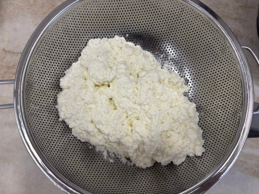 A strainer of cottage cheese
