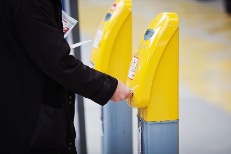 A passenger validating a train ticket