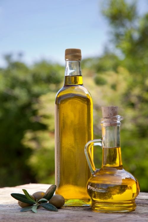 Olive oil on a table in a grove