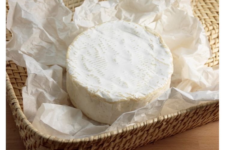 Brillat-Savarin cheese wheel in a basket